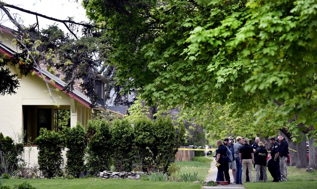 n In this May 6, 2015, photo, Missoula Police investigators gather outside a home shortly after the...