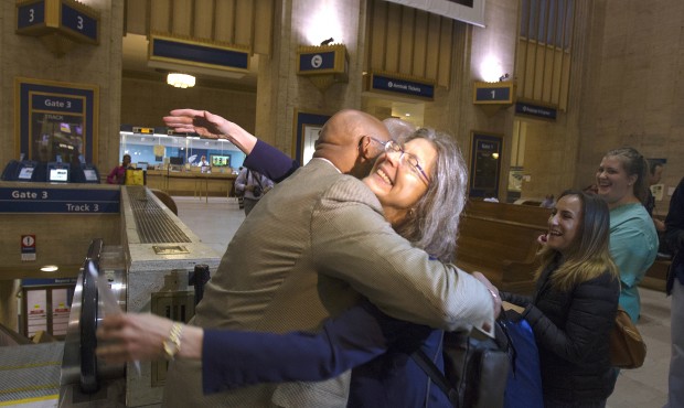 Philadelphia Mayor Michael Nutter hugs Mary Schaheen, the first passenger in line for Train 110 at ...