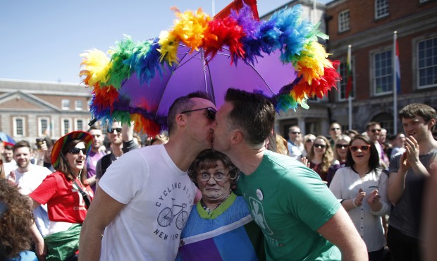 Two men kiss as first results start to filter through in the referendum, Dublin, Ireland, Saturday,...