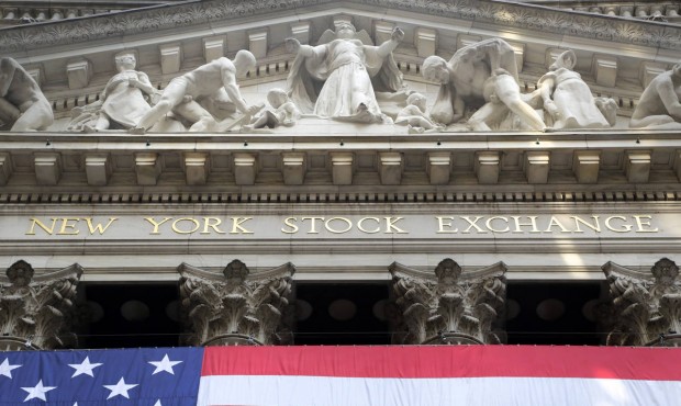In this July 6, 2015 photo, an American flag is draped on the exterior of the New York Stock Exchan...