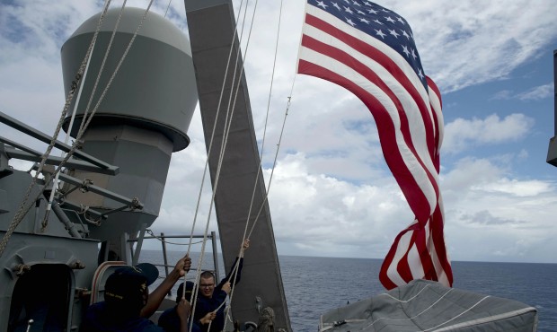 FILE – In this June 28, 2014 file photo, U.S. Navy personnel raise their national flag during...