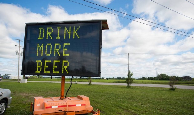 n An electronic road sign with the words “DRINK MORE BEER” is shown on Tuesday, June 23, 2015, ...