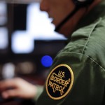 
              In this June 5, 2014 photo, a Border Patrol agent uses a headset and computer to conduct a long distance interview by video with a person arrested crossing the border in Texas, from a facility in San Diego. Hit with a dramatic increase of Central Americans crossing in South Texas, the Border Patrol is relieving staffing woes by enlisting agents in less busy sectors to process arrests through video interviews.  (AP Photo/Gregory Bull)
            