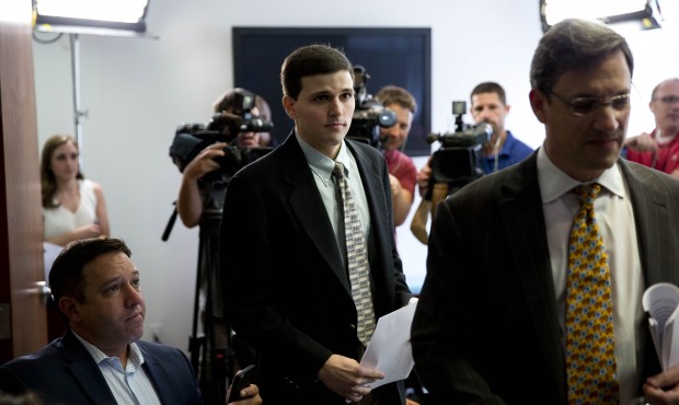 James Vivenzio, center, accompanied by his attorney Aaron J. Frewiald, arrives for news conference ...