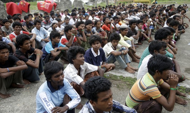 Ethnic Rohingya men gather near a temporary shelter in Langsa, Aceh province, Indonesia, Friday, Ma...
