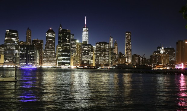 The Manhattan skyline, photographed from Brooklyn Bridge Park, shines in the dusk sky, Thursday, Ma...