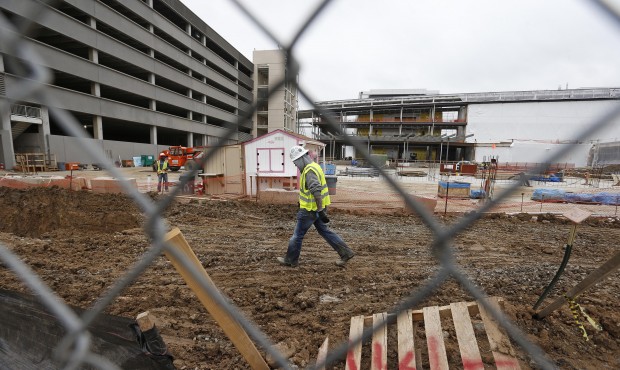 Members of a construction crew work at the site of the new Veterans Administration hospital complex...