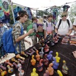 A group of teenaged boys look over a display of glass pipes at the first day of Hempfest, Friday, Aug. 16, 2013, in Seattle. Thousands packed the Seattle waterfront park for the opening of a three-day marijuana festival 