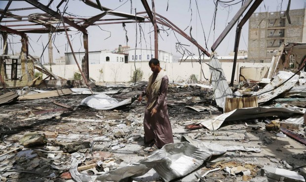 A man stands on the rubble of a wedding hall destroyed by a Saudi-led airstrike in Sanaa, Yemen, Fr...