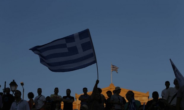 Supporters of the No vote wave Greek flags after the referendum’s exit polls at Syntagma squa...