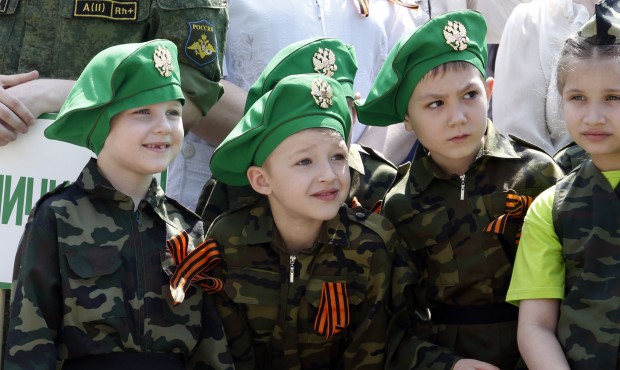Children wearing specially made uniforms, watch the so-called Kid Parade in Rostov-on-Don, Russia, ...