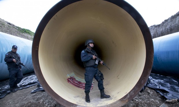 Federal police guard a drainage pipe outside of the Altiplano maximum security prison in Almoloya, ...
