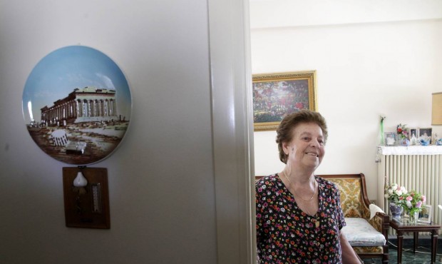Roza Alverti, 83, smiles at her house in Athens, Friday, July 10, 2015. The Greek government is rac...