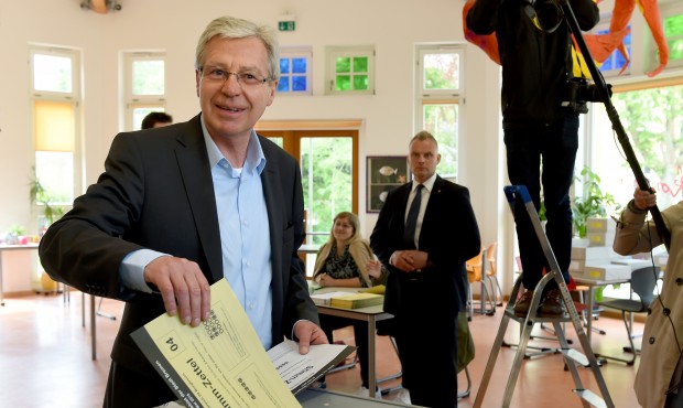 Mayor of Bremen Jens Boehrnsen casts his vote for the state election at a polling station in Bremen...