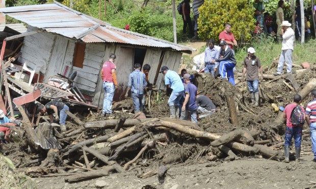Residents rescue belongings from houses damaged during an avalanche in Salgar, in Colombia’s ...