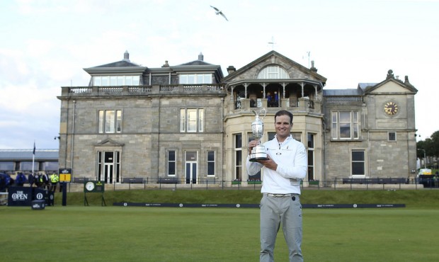 n United States’ Zach Johnson poses with the trophy after winning a playoff after the final round...