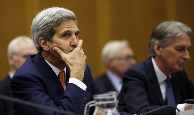 FILE – In this July 14, 2015 file-pool photo, Secretary of State John Kerry sits next to Brit...