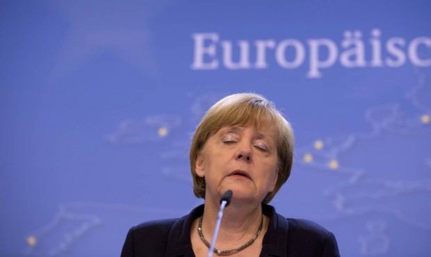 German Chancellor Angela Merkel listens to questions during a final media conference after an emerg...