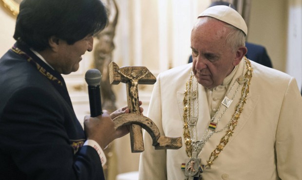 Pope Francis is presented with a gift of a crucifix carved into a wooden hammer and sickle, the Com...