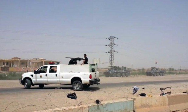 Arriving from Baghdad, federal police forces create a barricade to protect the Habaniyah military b...
