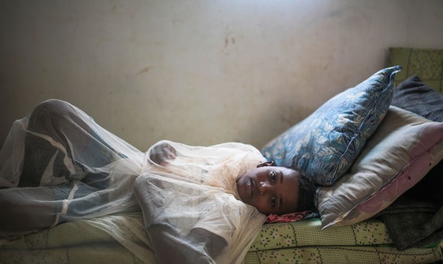 In this Tuesday, May 19, 2015 photo, Abo Bakr Mohammed, 12, who suffers from epilepsy, covers himse...