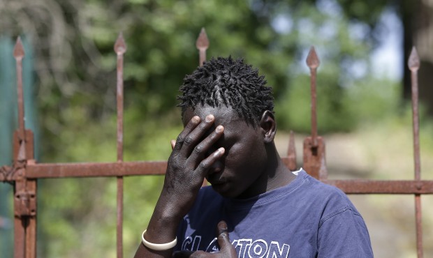 n Baboucar Lowe, a 17-year-old migrant from Gambia touches his head during an interview with the As...