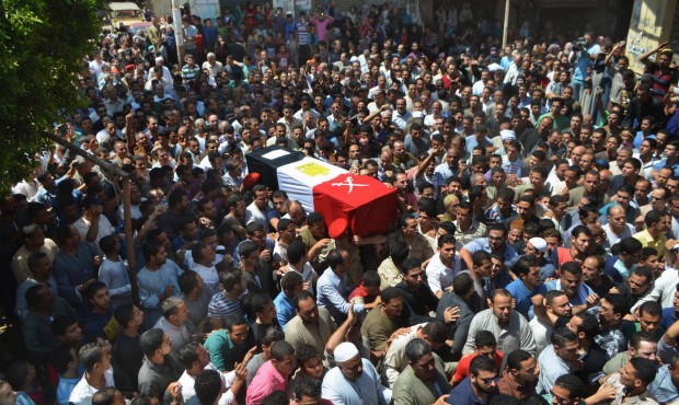FILE – In this Thursday, July 2, 2015, file photo, people carry the coffin for 1st Lt. Mohamm...
