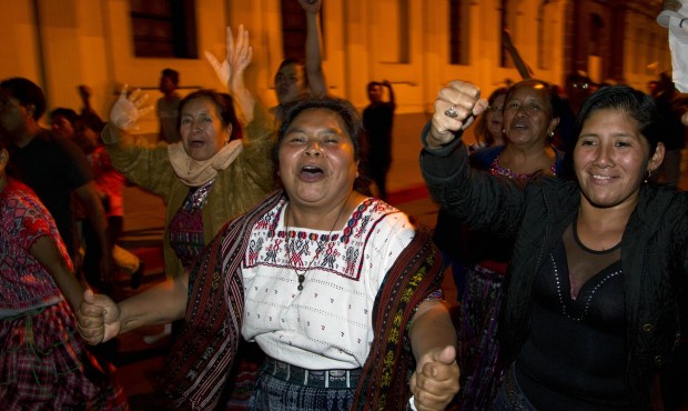 People celebrate near the Congress building after learning that Guatemala’s Vice President Ro...