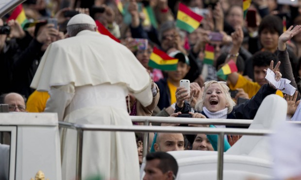 n Faithful cheer as Pope Francis arrives to celebrate Mass at Christ the Redeemer square in Santa C...