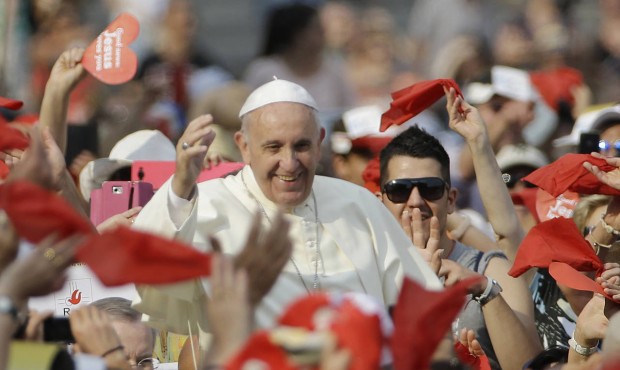 Pope Francis waves as he arrives for a meeting with faithful of the Holy Spirit movement in St. Pet...