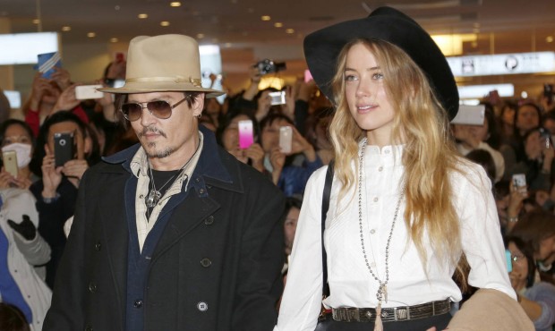 FILE – In this Jan. 26, 2015 file photo, U.S. actor Johnny Depp and Amber Heard arrive at Han...