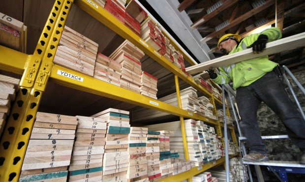 In this photo taken March 31, 2015, Ed Fotta sorts hardwood at the Allegheny Millwork and Lumberyar...