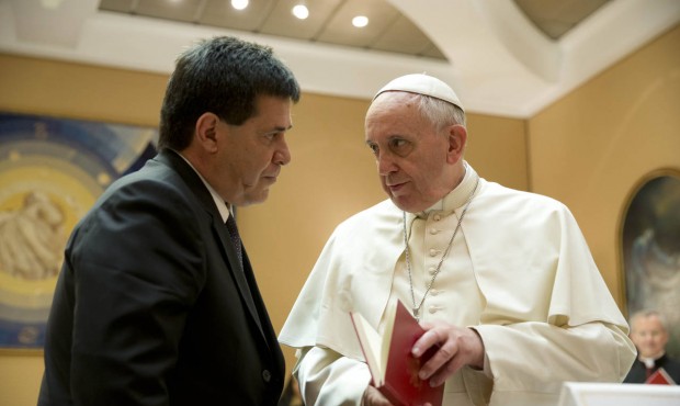 FILE – In this April 29, 2014 file photo, Pope Francis presents Paraguay’s President Ho...