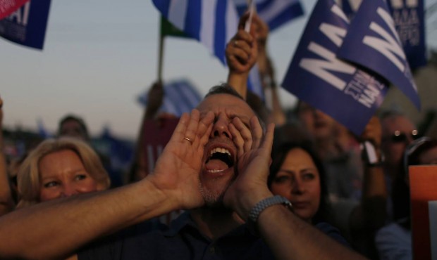 A demonstrator shouts slogans during a rally organized by supporters of the Yes vote in Athens, Fri...