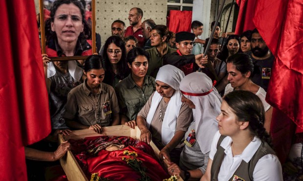 Mourners gather around the body of Gulay Ozarlan, a DHKP-C militant, that was killed in a gunfight ...