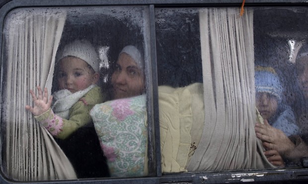 FILE – In this Dec. 20, 2012, file photo, Syrian refugees, who fled their home in Idlib due t...