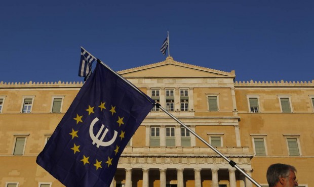 A pro-Euro demonstrator holds a European Union flag in front of Greek Parliament during a rally at ...