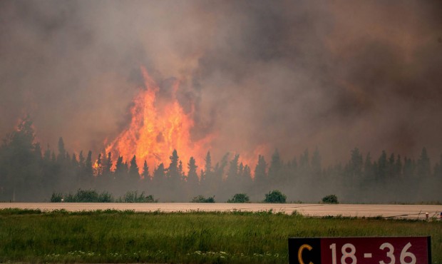 In this July 5, 2015 photo, flames rise from a wildfire near La Ronge, Saskatchewan. Canadian soldi...