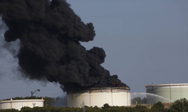 The smoke spreads in the sky from a fire in a tank of the U.S. Lyondellbasell chemicals group refin...