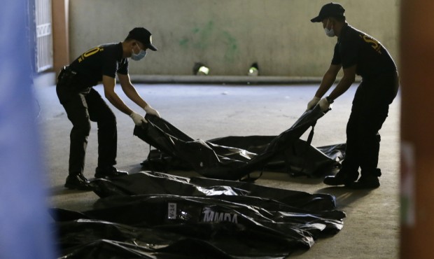 Members of Scene of the Crime Operatives of the Philippine National Police line up body bags contai...