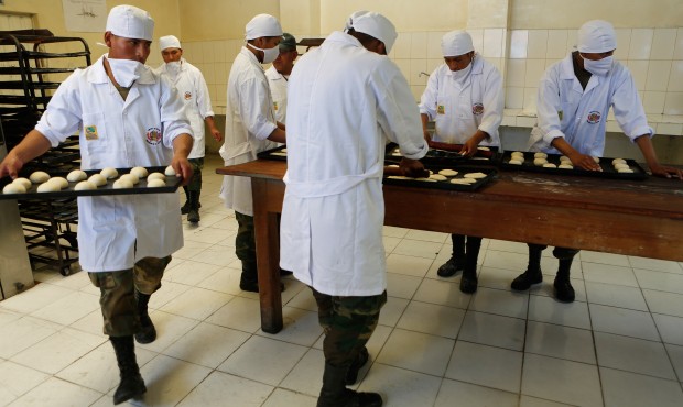 Bolivian soldiers make bread at the Miraflores army barracks in La Paz, Bolivia, Tuesday, May 19, 2...