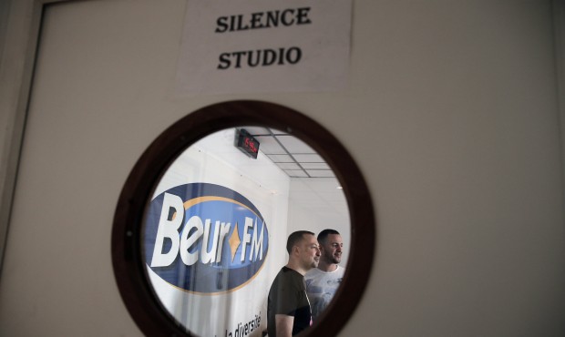 In this Friday, April 17, 2015 photo men work at Beur FM radio in Paris. It’s called “B...