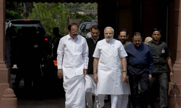 Indian Prime Minster Narendra Modi, center, accompanied by other ministers walks to address the med...