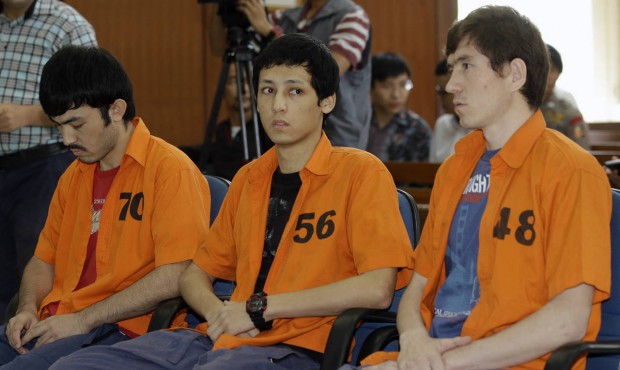 Suspected Islamic militants, from left to right, Abdulbasit Tuzer, Ahmet Mahmud and Abdullah sit on...