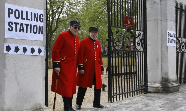 Chelsea Pensioners smile as they see the media after voting at a polling station in London, Thursda...