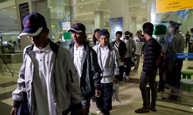 Myanmar fishermen arrive at Yangon International Airport, Thursday, May 14, 2015, in Yangon, Myanma...
