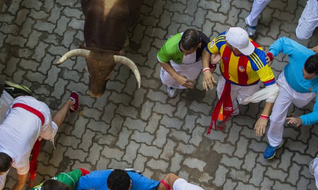 A Fuente Ymbro fighting bull runs after revelers during the running of the bulls, at the San Fermin...