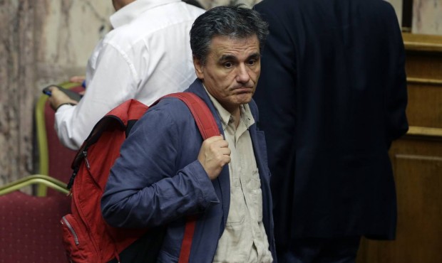 Greece’s Finance Minister Euclid Tsakalotos leaves after a parliament meeting in Athens, Thur...