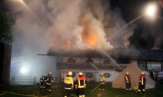 Firefighters try to extinguish a fire in the Bavarian town of Schneizlreuth , Germany, early Saturd...