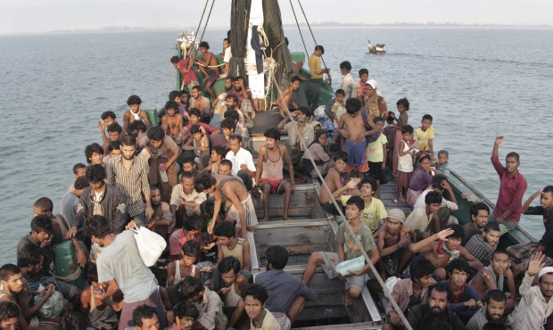 Migrants wait to be be rescued by Acehnese fishermen on their boat on the sea off East Aceh, Indone...